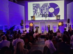 The Abbey Road album cover on the screen above the MartechNEXT stage.