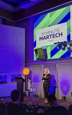 A speaker on stage beside a 10 Minute Martech screen at Abbey Road Studios.