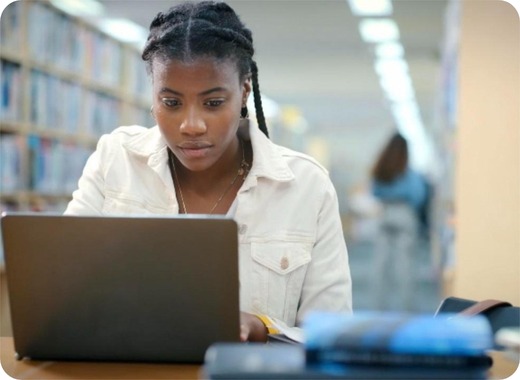 A student working on a laptop in a library